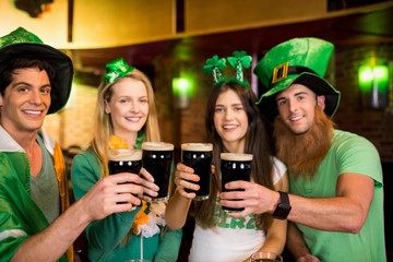 Smiling friends with Irish accessory