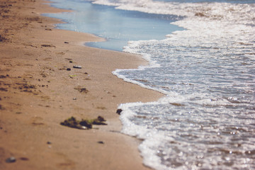 Foamy water on shore. Wet sand on the beach. Island amidst sea. Relax and forget about problems.