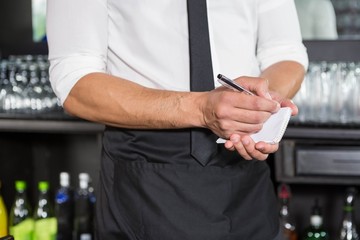 Waiter writing down an order