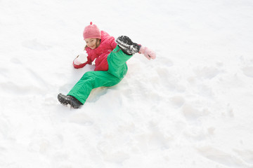 Playful girl with braids playing in snow