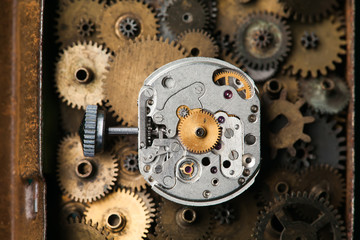 Aged mechanical clock macro view, rusty metal gears background. Shallow depth of field
