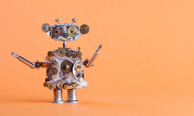 Steampunk style robot handyman with screwdriver. Funny toy mechanical character, repair service concept. Aged gears, cog wheel hand clock parts. Shabby grunge texture. Orange background, copyspace