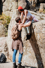 Man and woman teamwork climbing or hiking