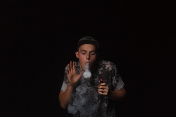 man smoking electronic cigarette lets rings of smoke