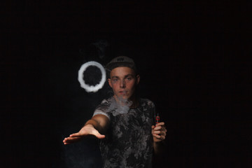man smoking electronic cigarette lets rings of smoke