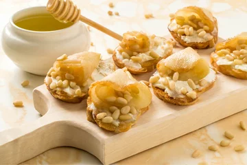 Gordijnen Canape with ricotta cheese, pears, nuts and honey © 13smile