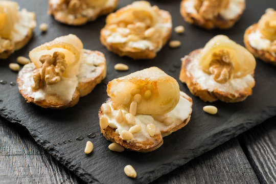 Canape with ricotta cheese, pears, nuts and honey