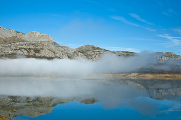Symmetry mist reflected in water.