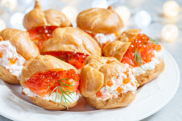 Profiteroles with fish and red caviar