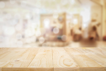 Empty wooden table space platform and blurred shopping mall or shopping center background for product display montage.