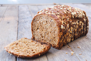 Close up of sliced fresh rustic wholemeal rye bread on a wooden
