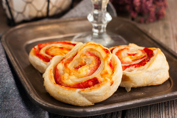 Rolls of puff pastry with ham and cheese