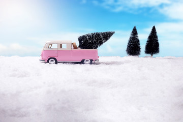 Christmas tree in toy car on sky background. Christmas holiday celebration concept.