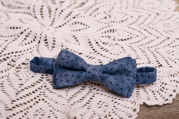 Bow tie and Crochet doily on wooden background