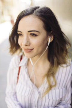 Woman listening music with earphone and cell phone
