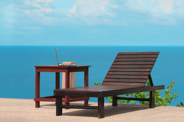 Fototapeta premium Working online from a tropical beach with laptop computer. Stock image.
