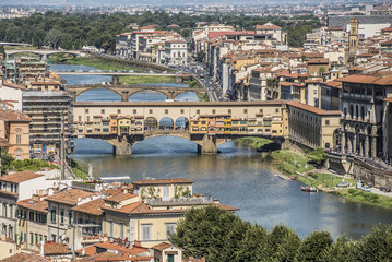 Fototapeta na wymiar Florence, Italy- August 12, 2016: Cityscape of the city of Florence with the Ponte Vecchio overlooking the Arno River in Florence, Italy