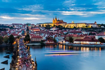  Pretty night time illuminations of Prague Castle, Charles Bridge and St Vitus Cathedral reflected in the Vltava river running through the heart of the city of Prague in the Czech Republic. © daliu