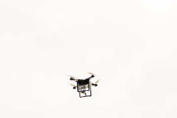 Black drone flying in the sky
