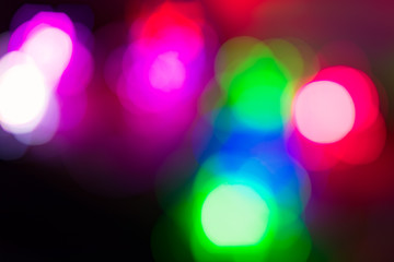 Background. Multi-colored lights of a Christmas garland in the background blurring