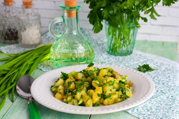 Potato salad on a white plate with fresh herbs
