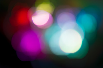 Background. Multi-colored lights of a Christmas garland in the background blurring
