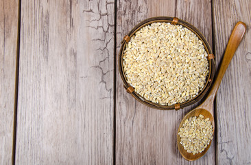 pearl barley in wooden bowl