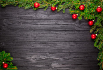 Fototapeta na wymiar Christmas fir tree on black wooden background