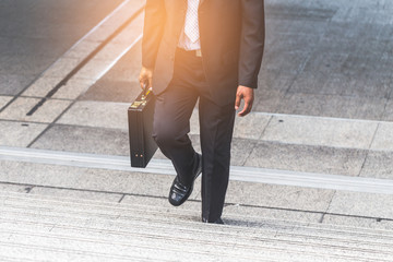 Businessman the stairs in a rush hour to work.