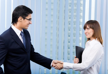 businesspeople, or businessman and client handshaking