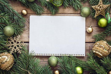 Christmas background with blank notebook, fir branches and decor