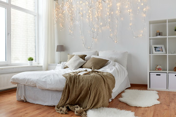 bedroom with bed and christmas garland at home