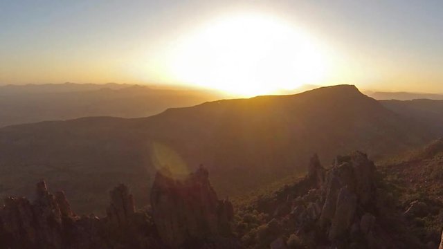 aerial view panorama of woman photographing the Valley of Desolation at sunset, Camdeboo National Park in South Africa.