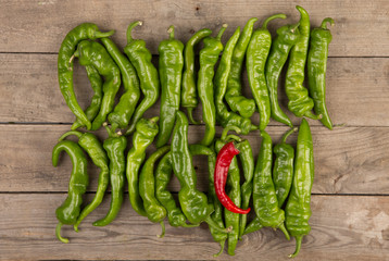 green pepperoni peppers on the wooden table