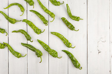 green pepperoni peppers on the wooden table