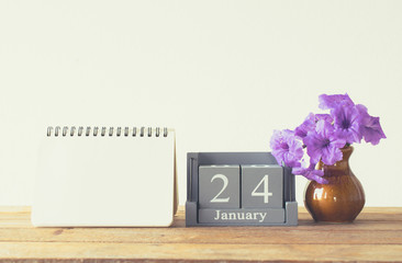 vintage wood calendar for january day 24 on wood table with empt