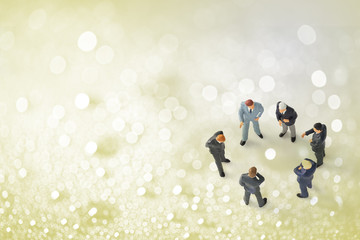 Fototapeta premium miniature businessmen on water drops bokeh background