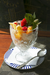 Ice cream with fruit and grated chocolate in a glass