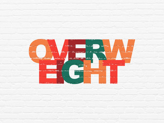 Healthcare concept: Overweight on wall background