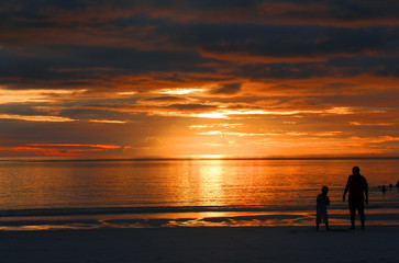Fototapeta premium father and son enjoying sunset at beach