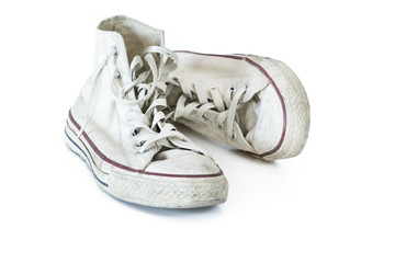 Old white sneakers on white background
