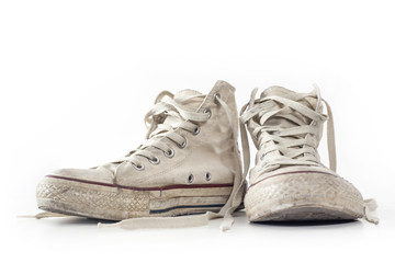 Old white sneakers on white background