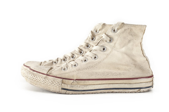 Old white sneakers on white background