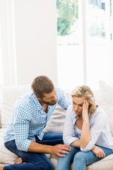 Man comforting her woman in living room