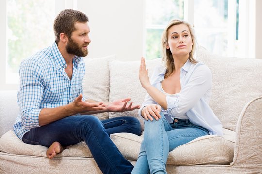 Upset couple arguing with each other