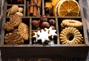 Fototapeta premium wooden box with Christmas sweets and spices on wooden table