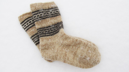 Warm knitted socks in the winter on snow
