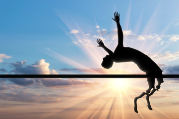 Paralympic handicapped with prosthetic jumps over crossbar