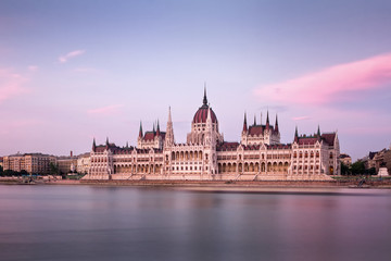 Fototapeta na wymiar The Hungarian Parliament on the Danube riverbank at nightfall
