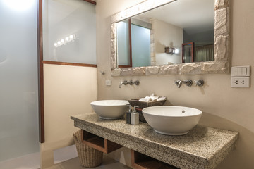 Fototapeta na wymiar Interior of a modern bathroom with twin sinks.